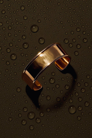 Layered bracelet look featuring chunky and delicate gold designs