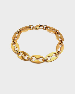 Gold chain bracelet on a light gray background