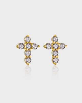Gold cross earrings with clear gemstones on a light gray background