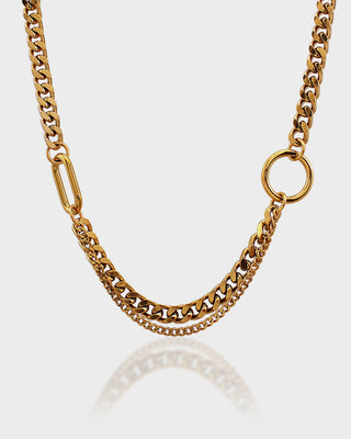 Gold chain necklace on a light gray background