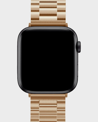 Smartwatch with a beige metal band on a light gray background