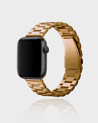 Smartwatch with a gold metal band on a light gray background