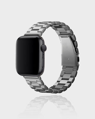 Smartwatch with a silver metal band on a light gray background