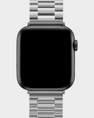 Smartwatch with a silver metal band on a light gray background