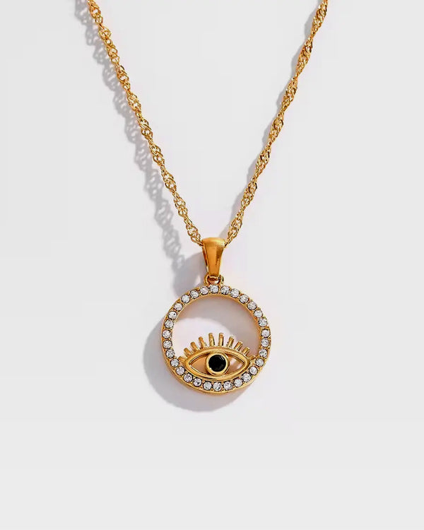 Discover the elegance of our Evil Eye Necklace, featuring gold-plated craftsmanship and sparkling crystals. A stylish accessory with spiritual protection and timeless beauty.