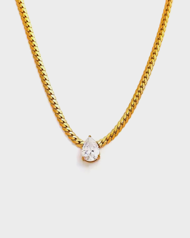 Elevate your style with the Icon Necklace, featuring a gold-plated chain and a stunning teardrop-cut crystal. Perfect for elegant everyday wear or special occasions.