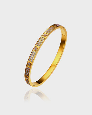 "Close-up of the Magnum Diamond Bracelet by Queen & Collection, featuring a sleek gold-plated band adorned with pavé-set diamonds, exuding luxury and sophistication."
