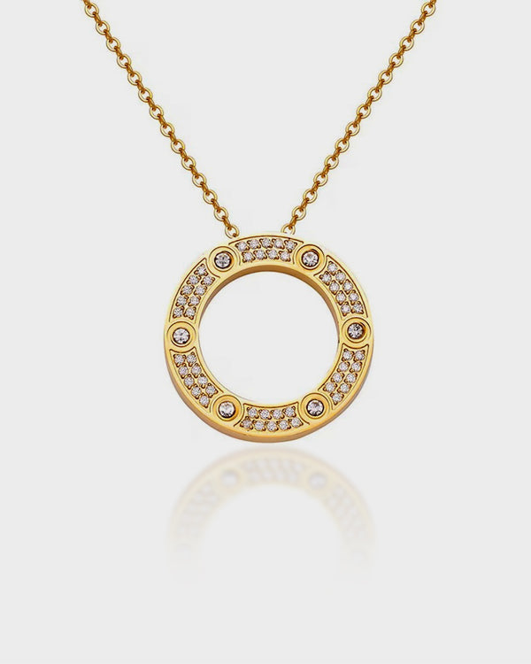 Gold necklace with a circular pendant on a light gray background
