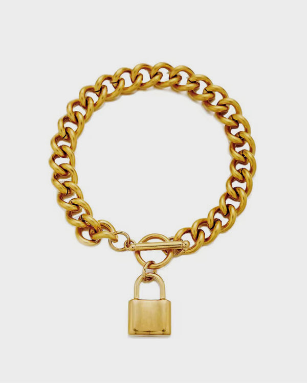 Gold chain bracelet with a padlock charm on a white background