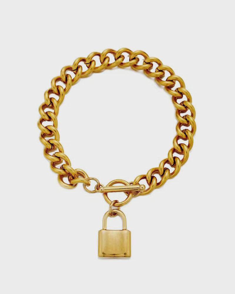 Gold chain bracelet with a padlock charm on a white background