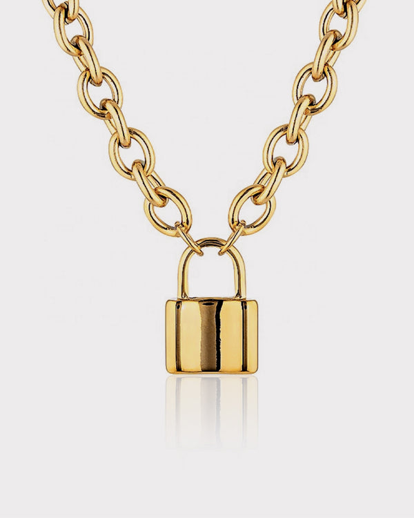 Gold chain necklace with a padlock pendant on a light gray background