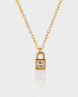 Gold padlock-shaped necklace with a diamond on a white background