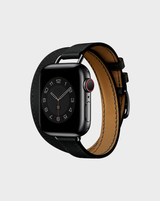 Smartwatch with a black case and brown leather strap on a light gray background