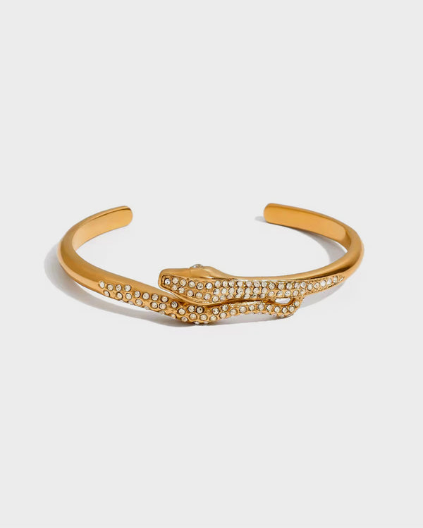 Gold bracelet with diamond accents on a white background