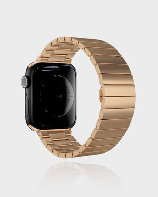 Smartwatch with a gold metal band on a light gray background
