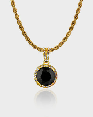 "Close-up of the Stella Necklace by Queen & Collection, featuring a bold black gemstone encased in a halo of crystals, suspended from a twisted gold rope chain."
