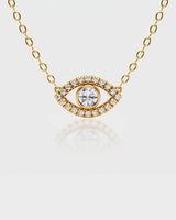 Gold necklace with an eye-shaped pendant on a light gray background