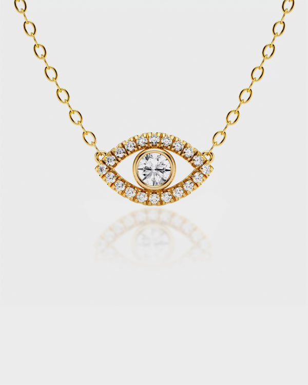 Gold necklace with an eye-shaped pendant on a light gray background