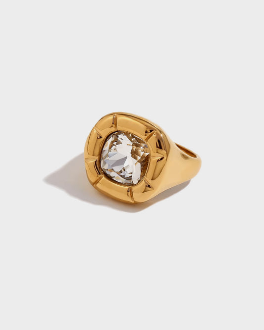 The Viva Ring by Queen and Co. features a striking cushion-cut crystal set in 18K gold plating. A bold, elegant statement piece designed for confidence and luxury.