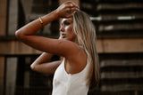 "Manifest Bracelet displayed against a neutral backdrop, highlighting its polished gold-plated finish and versatile design."


