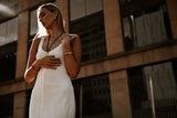 "Nirvana Necklace displayed against a neutral backdrop, accentuating its intricate gold detailing and timeless appeal."

