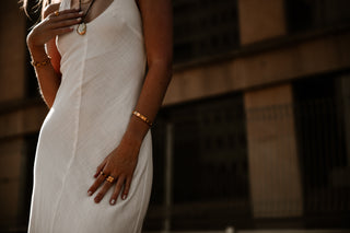 "Manifest Bracelet displayed against a neutral backdrop, highlighting its polished gold-plated finish and versatile design."

