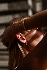 "Model wearing the Magnum Diamond Bracelet, showcasing its elegant design and radiant gold finish, perfect for both everyday wear and special occasions."

