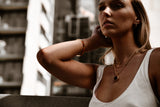"Bisous Earrings displayed against a neutral backdrop, highlighting their radiant gold finish and dazzling cubic zirconia accents that exude timeless elegance."

