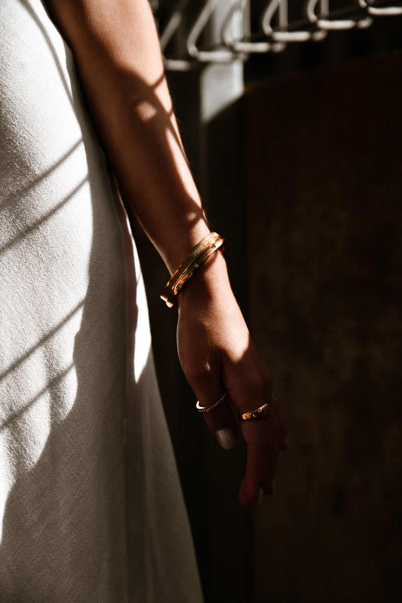 "Istanbul Bracelet displayed against a neutral backdrop, highlighting its polished gold-plated finish and the understated brilliance of its cubic zirconia embellishments."

