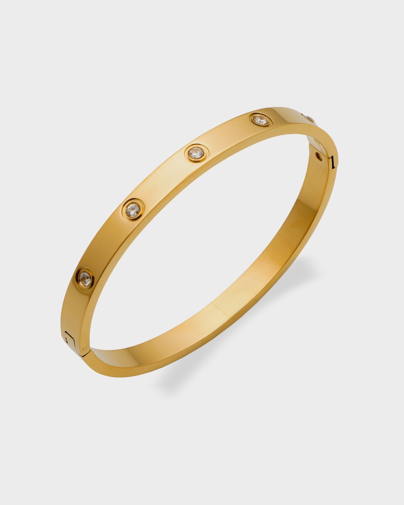 The Magnum Bracelet from Queen and Co. is a versatile, stackable piece crafted with 18K gold plating and zirconia accents. It is hypoallergenic, tarnish, and water-resistant, making it suitable for everyday wear. The bracelet combines affordability with luxury, offering a stylish accessory that complements various outfits.