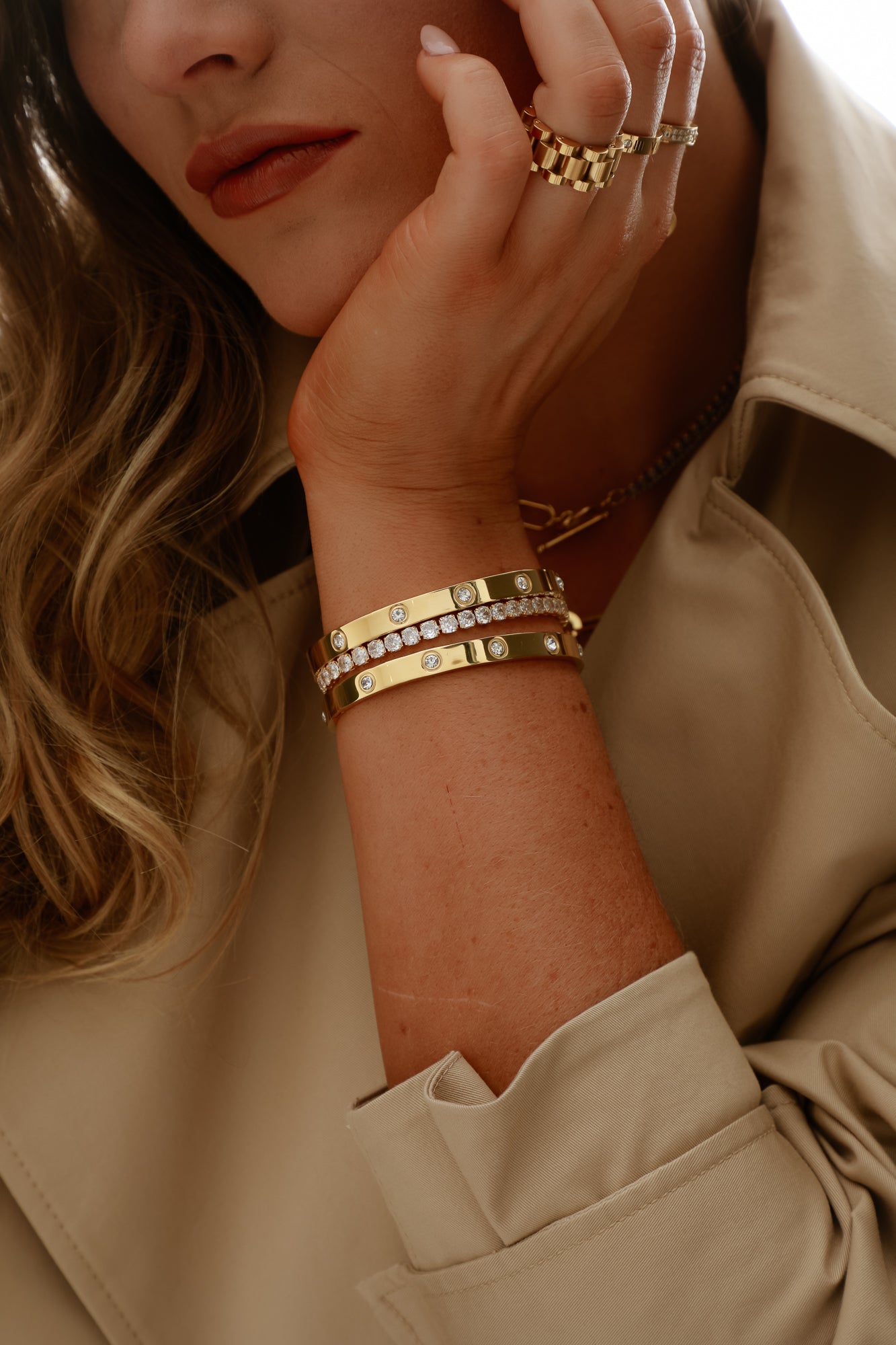 Elegant Tennis Bracelet with a single row of sparkling clear crystals set in a sleek, silver-tone band. The bracelet is shown on a white background, highlighting its refined design and luxurious shine.